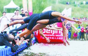 北京國際鐵人三項賽選手在園博湖魚躍入水